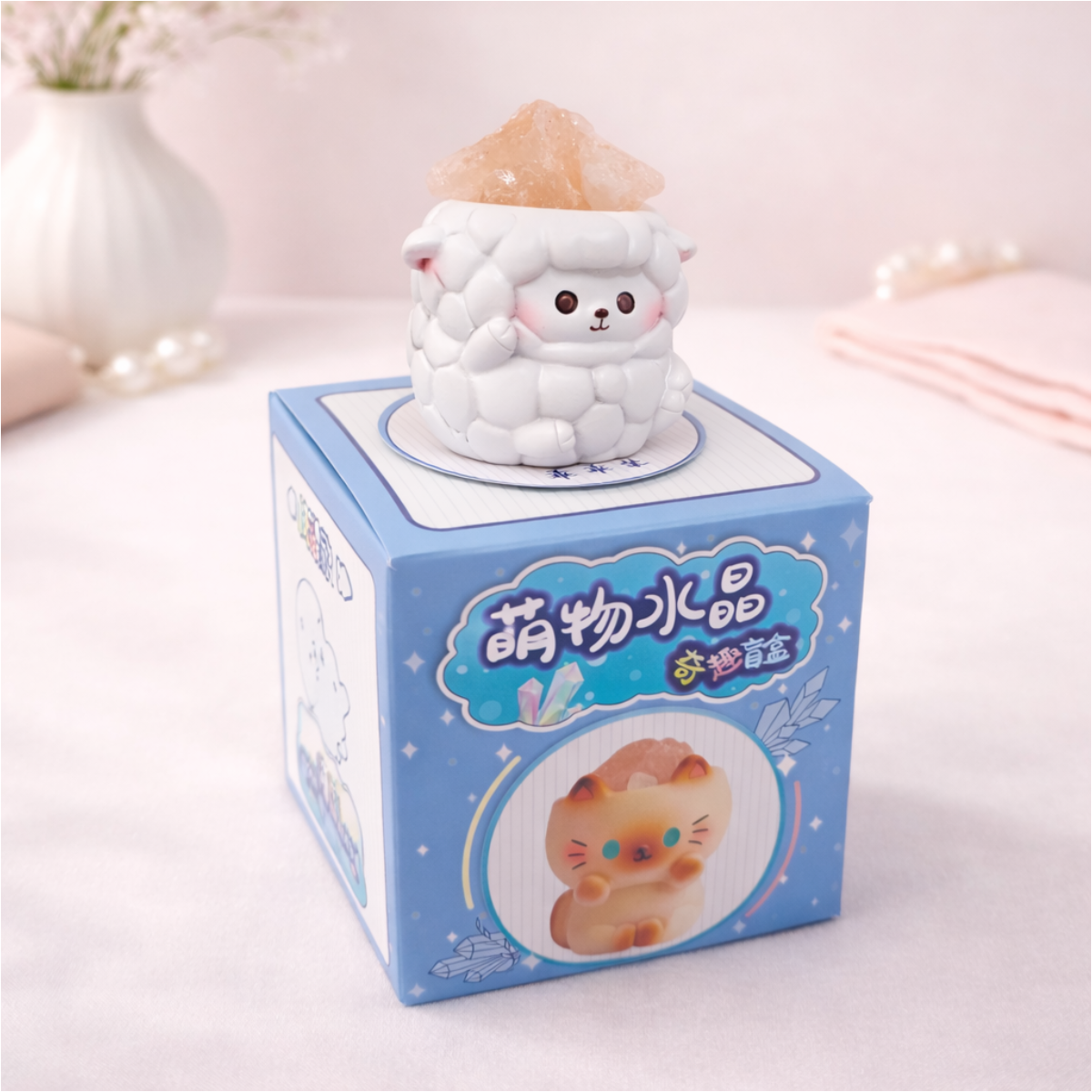 Cute sheep figurine holding a crystal on display box, kawaii animal collectible for desk and shelf decor.