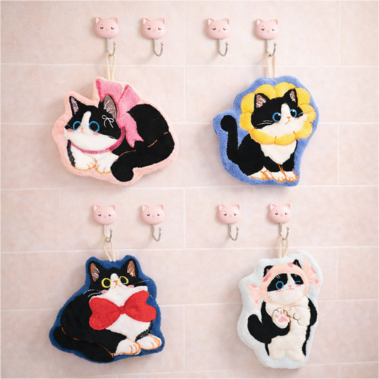 Cute plush cat bath towels hanging on hooks, kawaii animal hand towels for bathroom or kitchen use.