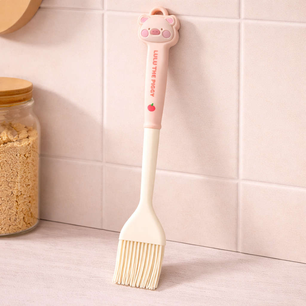 Cute silicone basting brush with cartoon handle, pastel kitchen baking tool for cooking and pastry use.