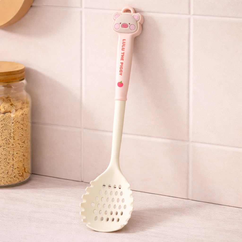 Cute silicone slotted spoon with cartoon pig handle, pastel kitchen cooking utensil for frying and straining.