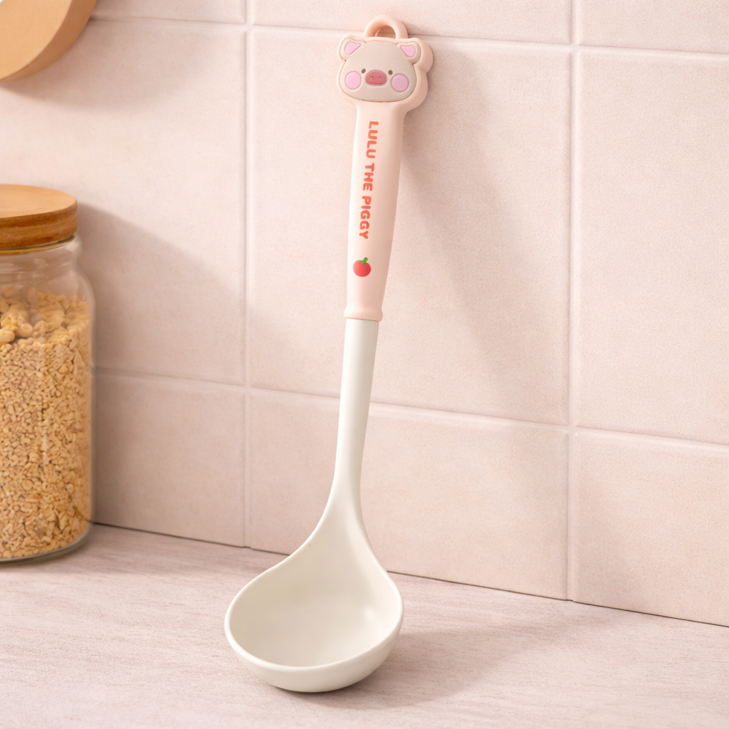 Cute silicone soup ladle with cartoon pig handle, pastel kitchen utensil for cooking and serving soups.