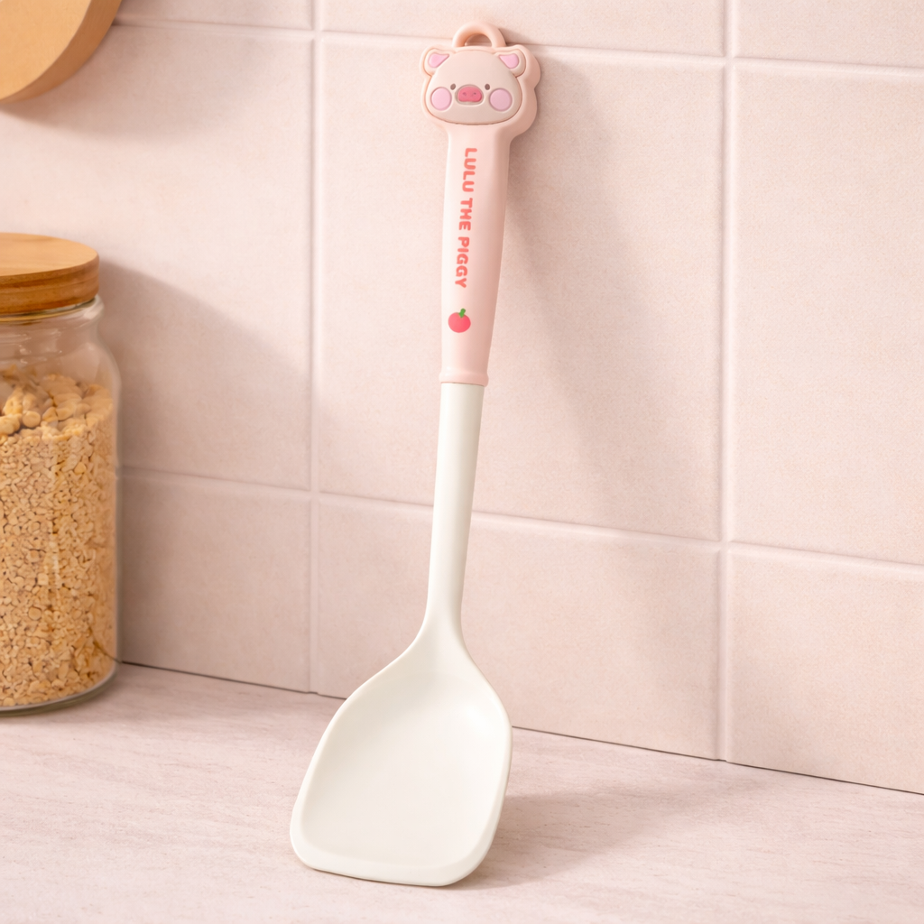 Cute silicone spatula with cartoon pig handle, pastel kitchen utensil for stirring and serving.