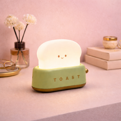Green toaster-shaped desk lamp with smiling face, cute pastel LED night light for desk or bedside decor.
