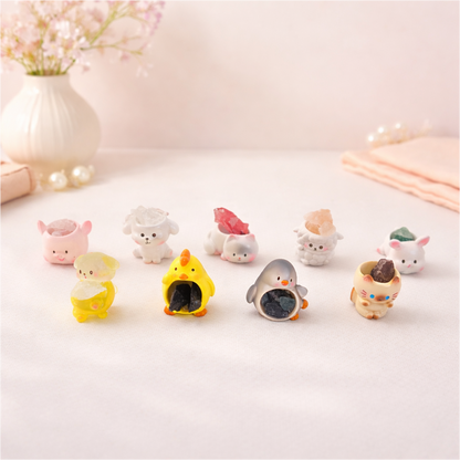 Cute mini animal figurines holding stones, kawaii desk decor collectibles for shelves and gift displays.