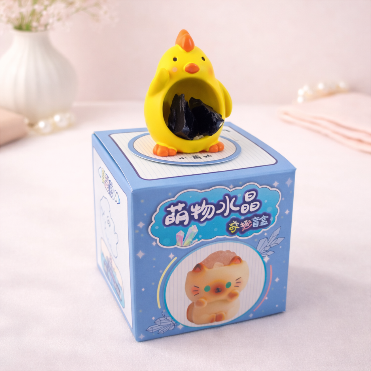 Cute yellow chick figurine holding a stone on display box, kawaii animal collectible for desk decor.