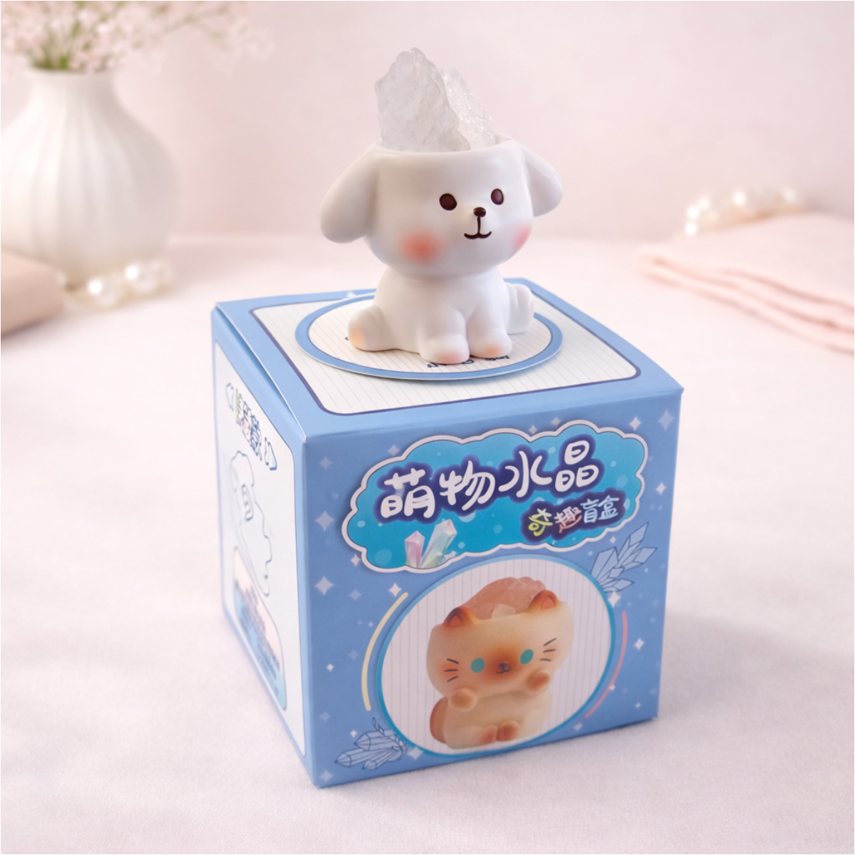Cute dog figurine holding a stone on display box, kawaii animal collectible for desk and shelf decor.