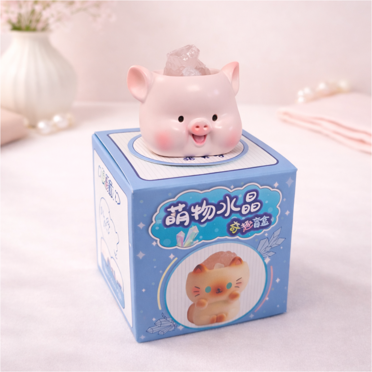 Cute pig figurine holding a crystal on display box, kawaii animal collectible for desk and shelf decor.