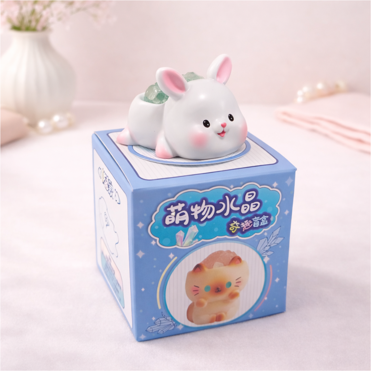 Cute white rabbit figurine holding a crystal on display box, kawaii animal collectible for desk and shelf decor.