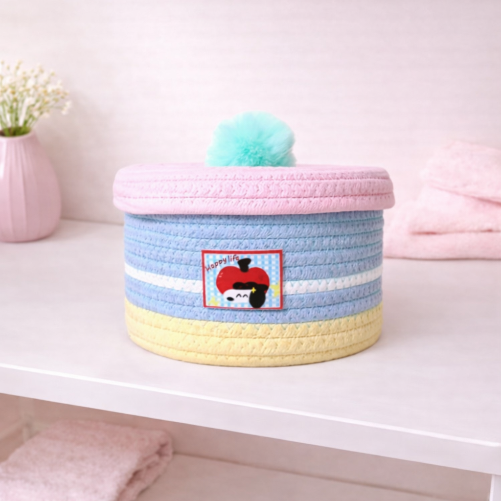 Round woven fabric storage box with pastel stripes and pom-pom lid, cute decorative organizer for shelf, desk, or nursery.