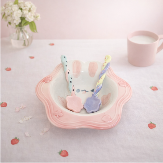 Cute rabbit-shaped ceramic bowl with two colorful spoons, kawaii tableware set for desserts and snacks.