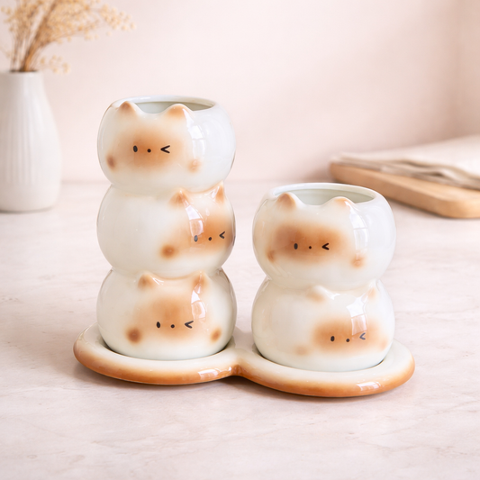Ceramic Siamese cat utensil holders with stacked design and tray, cute kitchen organizers for spoons or chopsticks.