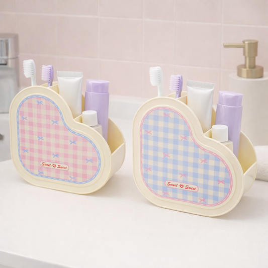 Heart-shaped bathroom organizers holding toothbrushes and toiletries, pastel storage caddies for sink or vanity.